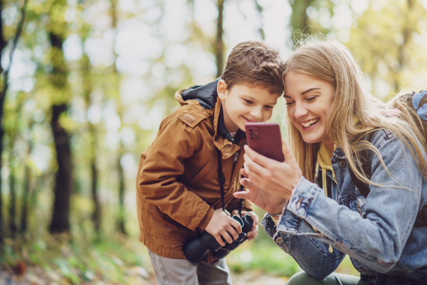mor og sønn ser på telefon